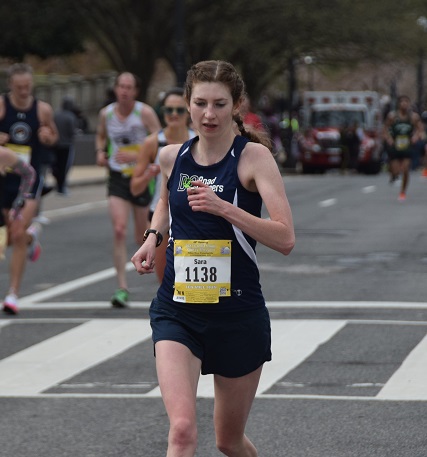 Sara Putterman running in the Cherry Blossom 10 Miler, wearing a navy blue DC Road Runners singlet